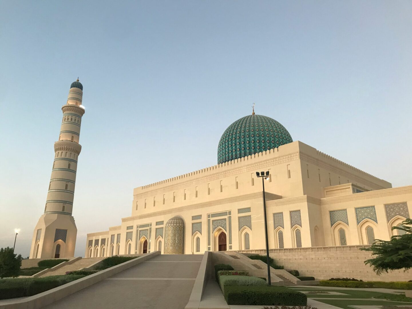 White mosque with green dome and minaret